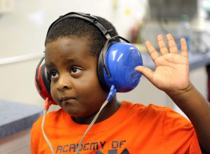 Child taking hearing loss test